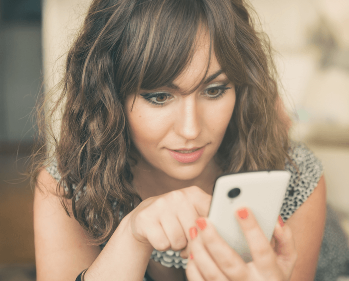 woman looking at mobile device